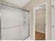 Clean walk-in shower with glass door and metal accents, alongside a well-organized walk in closet at 10992 Chapel Woods S Blvd, Noblesville, IN 46060