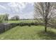 Backyard with a well-maintained lawn and surrounding fence and trees at 110 Meadow Creek Blvd, Whiteland, IN 46184