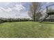 Grassy backyard with privacy fence and access to a deck at 110 Meadow Creek Blvd, Whiteland, IN 46184