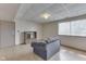 Partially furnished basement with a gray sofa and built-in shelving near the window at 110 Meadow Creek Blvd, Whiteland, IN 46184