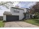 Two-story home featuring a two-car garage, manicured lawn, and cozy front porch at 110 Meadow Creek Blvd, Whiteland, IN 46184