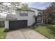 Two-story home featuring a two-car garage, manicured lawn, and cozy front porch at 110 Meadow Creek Blvd, Whiteland, IN 46184