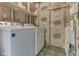 Functional laundry area with a washer and dryer, featuring storage shelves and utilities at 110 Meadow Creek Blvd, Whiteland, IN 46184