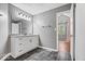 Bathroom with single vanity, dark gray floor tiles and views into the main bedroom at 11424 Geist Valley Dr, Indianapolis, IN 46236