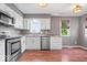 Well-lit kitchen featuring white cabinetry, granite countertops, and stainless steel appliances at 11424 Geist Valley Dr, Indianapolis, IN 46236