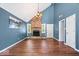 Open living area with a brick fireplace, hardwood floors, and plenty of space at 11424 Geist Valley Dr, Indianapolis, IN 46236