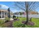 Well-manicured backyard with patio seating, lush landscaping, and fenced perimeter at 1275 Cliff View Dr, Westfield, IN 46074