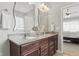Elegant bathroom featuring double sinks, granite countertops, and dark wood cabinetry at 1275 Cliff View Dr, Westfield, IN 46074