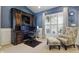Elegant home office with custom built-ins, comfortable seating, and ample natural light at 1275 Cliff View Dr, Westfield, IN 46074