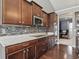 Updated kitchen features granite countertops, tile backsplash, and stainless steel appliances at 1275 Cliff View Dr, Westfield, IN 46074