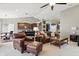 Cozy living room showcasing a leather furniture set adjacent to a kitchen with modern bar seating at 1275 Cliff View Dr, Westfield, IN 46074