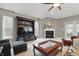 Vaulted living room with a built-in entertainment center, fireplace, and comfortable seating at 1275 Cliff View Dr, Westfield, IN 46074