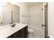 Bright bathroom with a dark vanity, white countertops, and a clean, modern bathtub at 13323 Susser Way, Fishers, IN 46037