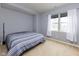 Simple bedroom with carpet, blue accent wall, large windows with curtains, and a comfortable bed at 13323 Susser Way, Fishers, IN 46037