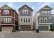 Charming exterior showcasing a two-story home with a gray siding, front-facing garage, and neat landscaping at 13323 Susser Way, Fishers, IN 46037