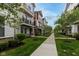 Exterior shot of townhomes, showing a walkable neighborhood with grassy lawns and mature trees in Fishers, IN at 13323 Susser Way, Fishers, IN 46037