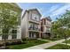 Neighborhood street view showcasing modern homes with inviting front yards and green trees under blue skies at 13323 Susser Way, Fishers, IN 46037