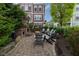 Outdoor fireplace area featuring a stone fireplace, chairs, and a patio for relaxation and entertainment at 13323 Susser Way, Fishers, IN 46037