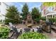 Outdoor fireplace area featuring a stone fireplace, chairs, and a patio for relaxation and entertainment at 13323 Susser Way, Fishers, IN 46037