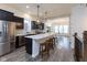 Modern kitchen featuring stainless steel appliances, dark cabinets, a center island, and breakfast bar at 13323 Susser Way, Fishers, IN 46037