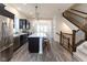 Modern kitchen with stainless steel appliances, dark cabinets, and a large center island at 13323 Susser Way, Fishers, IN 46037