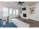 Cozy living room featuring a fireplace with built-in bookshelves and french doors to a small balcony at 13323 Susser Way, Fishers, IN 46037