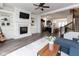 Open concept living room flowing into the kitchen with a modern fireplace and hardwood floors at 13323 Susser Way, Fishers, IN 46037