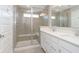 Elegant bathroom with dual vanity, sleek shower featuring glass door, and tiled walls at 13776 Tender Dr, Carmel, IN 46032