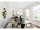 Formal dining area features an oval table, six chairs, and sleek modern decor for elegant meals at 13776 Tender Dr, Carmel, IN 46032