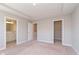 Neutral empty room boasts a tray ceiling, access to an ensuite bath, and a walk-in closet at 13776 Tender Dr, Carmel, IN 46032