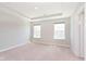 Clean, empty room with soft carpet, tray ceiling, and natural light from two windows at 13776 Tender Dr, Carmel, IN 46032