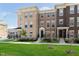 Attractive brick townhomes featuring well-maintained lawns, black railings, and contemporary architectural details at 13776 Tender Dr, Carmel, IN 46032