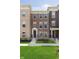 Charming brick townhome with a well-manicured lawn, showcasing a welcoming entrance and classic architectural details at 13776 Tender Dr, Carmel, IN 46032