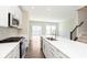 Open kitchen with quartz countertops, stainless appliances, and view to living area at 13776 Tender Dr, Carmel, IN 46032