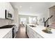 Open kitchen concept featuring stainless appliances and sightlines into dining and living spaces at 13776 Tender Dr, Carmel, IN 46032