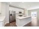 Bright kitchen featuring stainless steel appliances, quartz countertops, and a large island at 13776 Tender Dr, Carmel, IN 46032