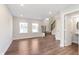 Open-concept living room with hardwood floors, large windows, and staircase with iron railing at 13776 Tender Dr, Carmel, IN 46032