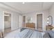 Stylish primary bedroom showcases a sleek tray ceiling, ensuite bath, and walk-in closet entrances at 13776 Tender Dr, Carmel, IN 46032