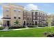 Row of brick townhomes with landscaped front yards, combining classic design with inviting curb appeal at 13776 Tender Dr, Carmel, IN 46032