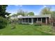 A backyard with a sun room addition and green grass at 1402 Arcola Ct, Beech Grove, IN 46107