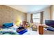 Cozy bedroom with window, bike, and patterned wall at 1402 Arcola Ct, Beech Grove, IN 46107