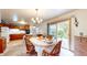Cozy dining area features a chandelier, a sliding glass door, and wood furniture at 1402 Arcola Ct, Beech Grove, IN 46107