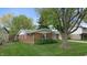 Charming brick home with a well-maintained lawn and mature trees in a suburban neighborhood at 1402 Arcola Ct, Beech Grove, IN 46107