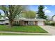 Charming single-story brick home featuring a well-manicured lawn and attached one-car garage at 1402 Arcola Ct, Beech Grove, IN 46107