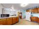 Bright kitchen with laminate floors, an island, and ample counter space at 1402 Arcola Ct, Beech Grove, IN 46107