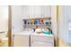 A laundry room featuring a washer, dryer, and overhead shelves at 1402 Arcola Ct, Beech Grove, IN 46107