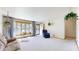 Bright living room with large window, neutral carpet, and comfortable seating at 1402 Arcola Ct, Beech Grove, IN 46107