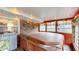 Sunroom featuring a hot tub surrounded by paneled wood and a brick wall at 1402 Arcola Ct, Beech Grove, IN 46107