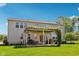 Back exterior showcases a well-kept lawn, a patio with a pergola, and mature trees, perfect for relaxation at 14162 Nicholas Dr, Carmel, IN 46074