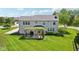 View of the home and backyard with mature trees and a pergola-covered patio at 14162 Nicholas Dr, Carmel, IN 46074